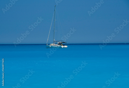 Sailboat on the totally blue sea and sky of Kefalonia island in Greece