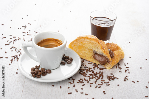 breakfast with coffee and chocolate croissant brioches on a light background