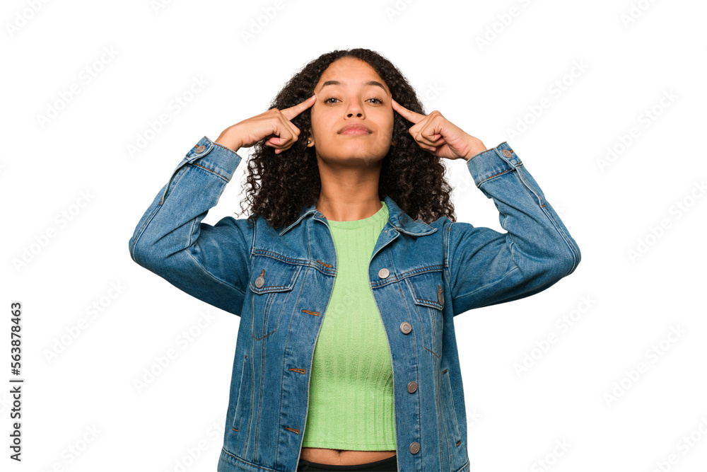 Young african american curly woman isolated focused on a task, keeping forefingers pointing head. Young african american curly woman isolated focused on a task, keeping forefingers pointing head.