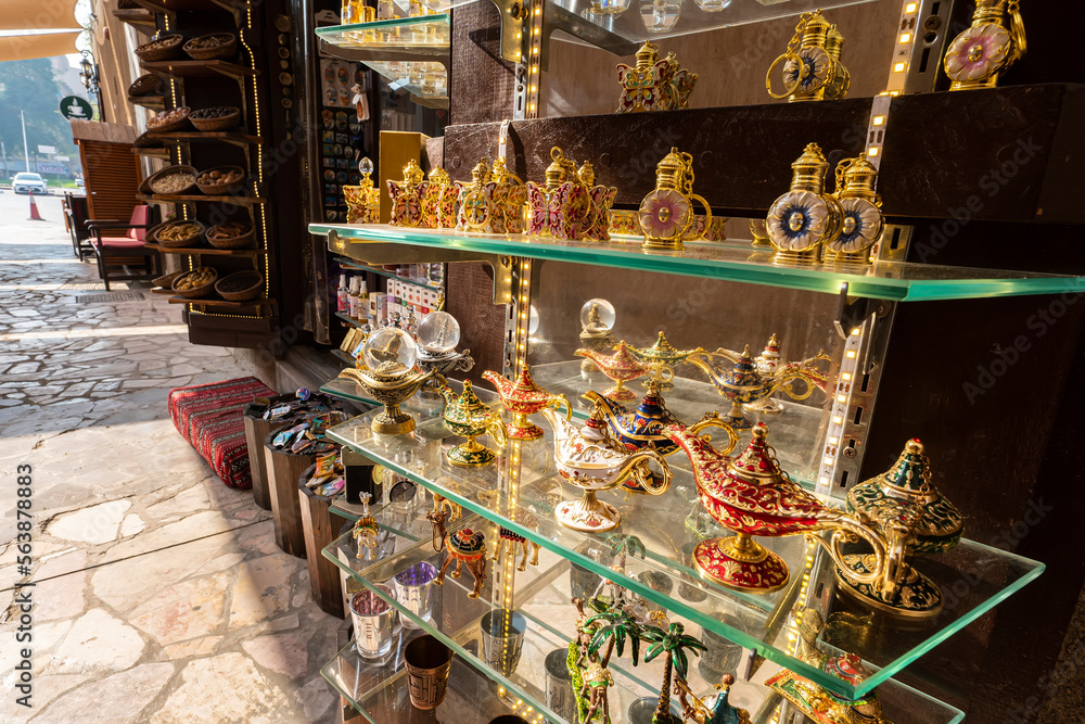 Various colorful expensive souvenirs on the counter in the store at the bazaar in the old city of Dubai. United Arab Emirates.