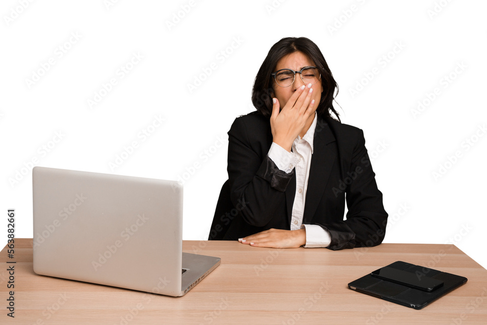 Young indian woman in a table with a laptop and tablet isolated yawning showing a tired gesture covering mouth with hand. Young indian woman in a table with a laptop and tablet isolated yawning showing a tired gesture covering mouth with hand.