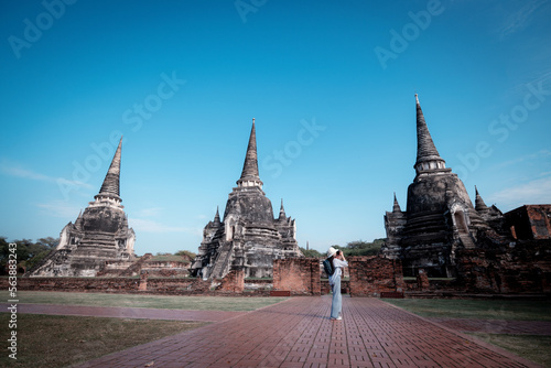 Portrait pretty young woman pose having fun and happy in famous the ancient palace in Ayutthaya with camera travel with take photo is travel holiday relaxed concept.