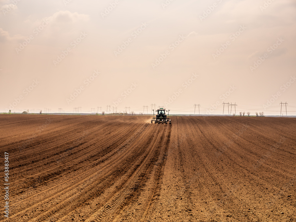 Farmer sowing soybean seeds in a field with modern equipment Farmer sowing soybean seeds in a field with modern equipment