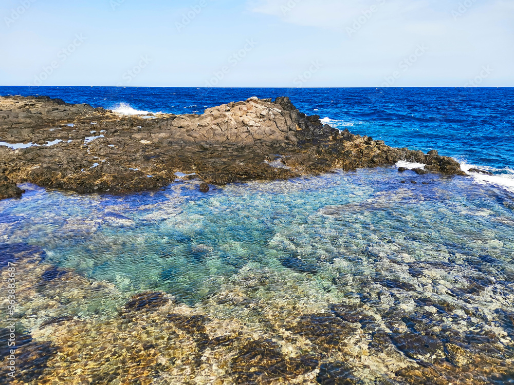 Atlantic Ocean with a natural pool in Caleta de Fuste, Fuerteventura, Spain