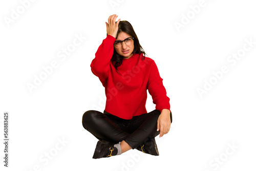 Obraz na plátně Young indian woman sitting on the floor cut out isolated forgetting something, slapping forehead with palm and closing eyes