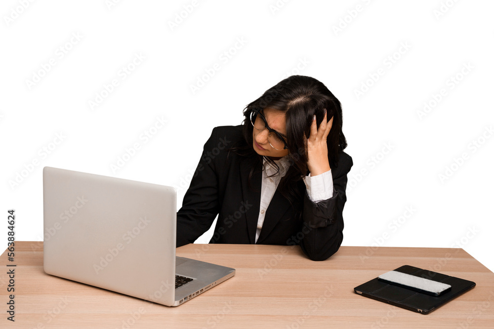 Young indian woman in a table with a laptop and tablet using a mobile phone isolated Young indian woman in a table with a laptop and tablet using a mobile phone isolated