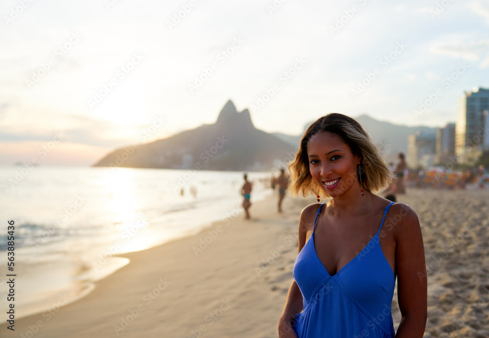 portrait young smiling Brazilian woman at Ipanema beach shore at sunset portrait young smiling Brazilian woman at Ipanema beach shore at sunset