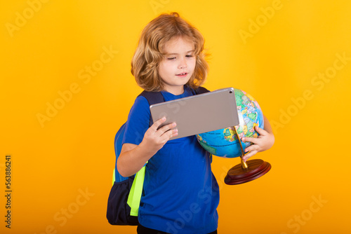 School boy world globe and tablet. Kid boy from elementary school with book. Little student, smart nerd pupil ready to study. Concept of education and learning.