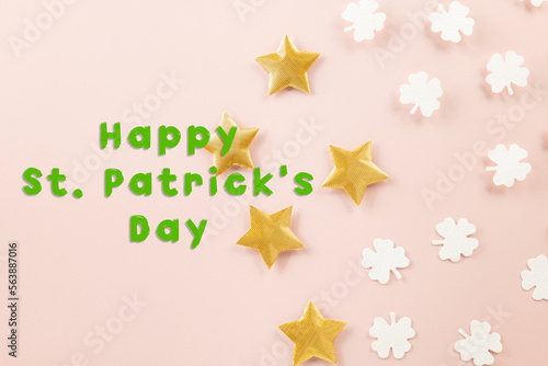 Happy St Patricks Day decoration background. above top view of paper clover leaves festive decor  shamrocks leaves holiday symbol with copy space on colour background  Banner greeting card concept