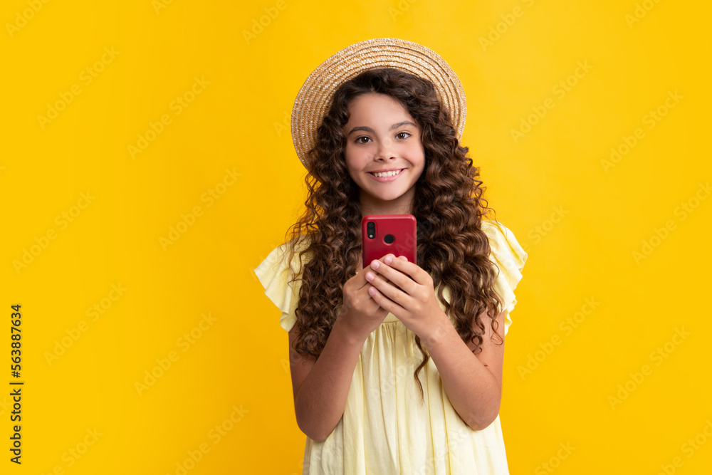 Teenager child using mobile phone, chatting on web. Mobile app for smartphone. Children lifestyle concept. Happy teenager, positive and smiling emotions of teen girl. Teenager child using mobile phone, chatting on web. Mobile app for smartphone. Children lifestyle concept. Happy teenager, positive and smiling emotions of teen girl.