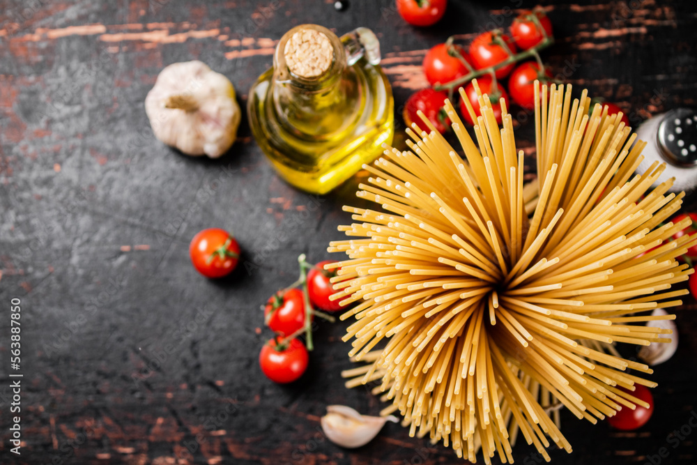 Not cooked spaghetti dry. Against a dark background. Not cooked spaghetti dry. Against a dark background.