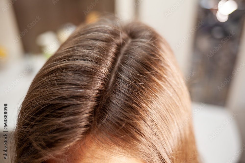 Fototapeta premium The process of preparing a hair ribbon for extension at home. Hair extensions to thicken your own. Individual strands of hair close-up