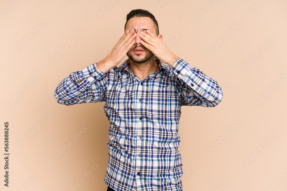 Adult latin man cut out isolated afraid covering eyes with hands. Adult latin man cut out isolated afraid covering eyes with hands.