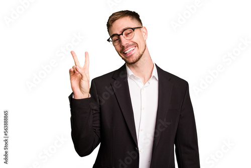 Young caucasian business man cutout isolated joyful and carefree showing a peace symbol with fingers.