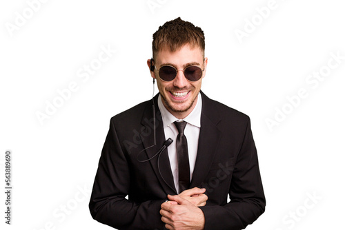 Security bodyguard man wearing a suit isolated cut out laughing and having fun.