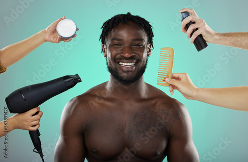 Hair, makeover and salon treatment with man in studio portrait with smile, hairdryer and comb on green background. Beauty, haircare and product for happy male model with natural hairstyle at barber. photo