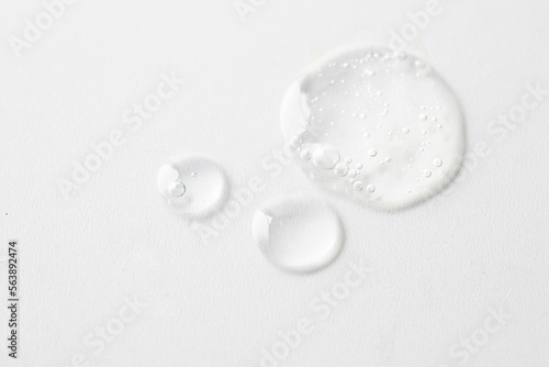 Ttransparent smear sample with bubbles texture on white isolated background. Skin care y body treatment photo