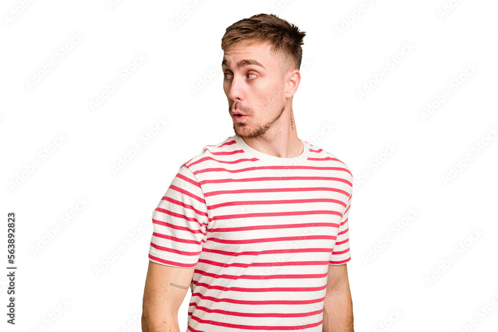 Obraz premium Young caucasian man cut out isolated looks aside smiling, cheerful and pleasant.