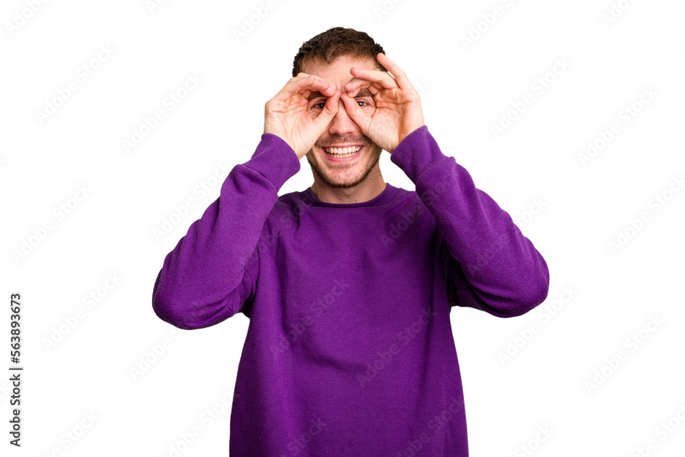 Young caucasian man cut out isolated showing okay sign over eyes Young caucasian man cut out isolated showing okay sign over eyes