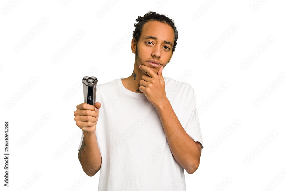 Young African American man holding a razor isolated looking sideways with doubtful and skeptical expression. Young African American man holding a razor isolated looking sideways with doubtful and skeptical expression.