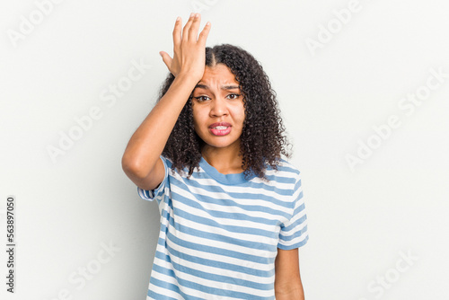 Young african american woman isolated on white background forgetting something, slapping forehead with palm and closing eyes.