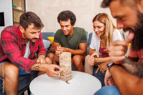 Wallpaper Mural Friends having fun playing jenga at home Torontodigital.ca