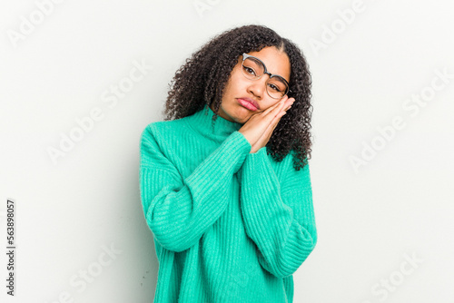 Young african american woman isolated on white background yawning showing a tired gesture covering mouth with hand.