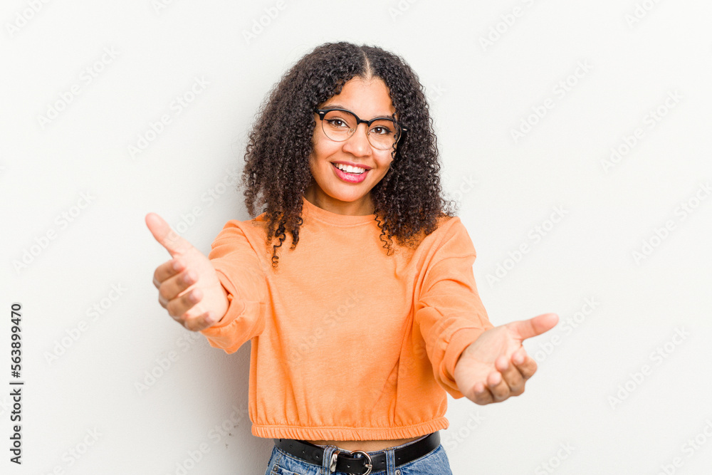 Young african american woman isolated on white background showing a welcome expression. Young african american woman isolated on white background showing a welcome expression.
