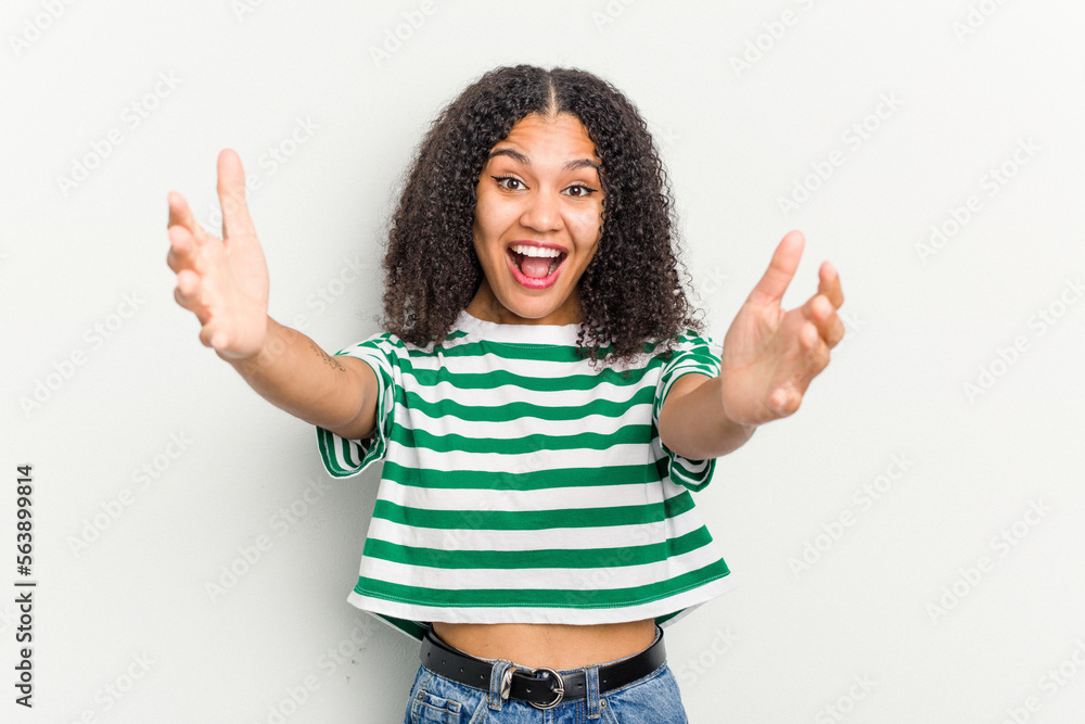 Young african american woman isolated on white background celebrating a victory or success, he is surprised and shocked. Young african american woman isolated on white background celebrating a victory or success, he is surprised and shocked.