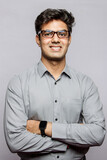 Young Sophisticated Indian handsome adult wearing a shirt and glasses smiling against the studio background. Eligible Indian boy wedding, Indian matrimony.