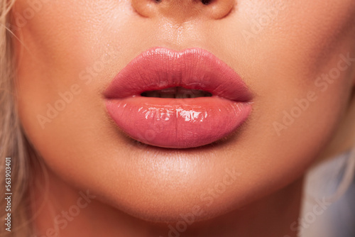Close up lips. Sexy pink lips close up. Beautiful Perfect Makeup. macro. Beautiful pink Lip Gloss. advertising. Cosmetic. Mouth open, big lips.   photo
