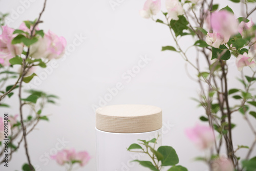 empty wooden podium blurred pink flowers decoration on white background with space.beauty cosmetic and romantic valentines or mother,birthday woman love gift product pedestal platform stand display.