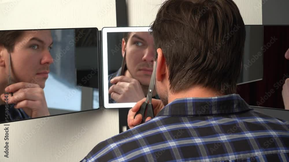 A man hangs a smart mirror on the door. A man shows off his beauty in front of a modern smart mirror. Smart mirror with backlight A man hangs a smart mirror on the door. A man shows off his beauty in front of a modern smart mirror. Smart mirror with backlight