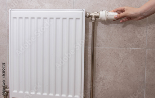 Wallpaper Mural A woman regulates the gas heating in the room in order to save gas energy, taking into account the sanctions. Comfortable heating in the house. Copy space for text Torontodigital.ca