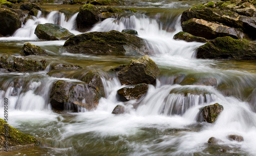 Water concept river water flowing with light reflecting  long exposure light spots   