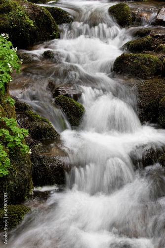 Water concept river water flowing with light reflecting  long exposure light spots   