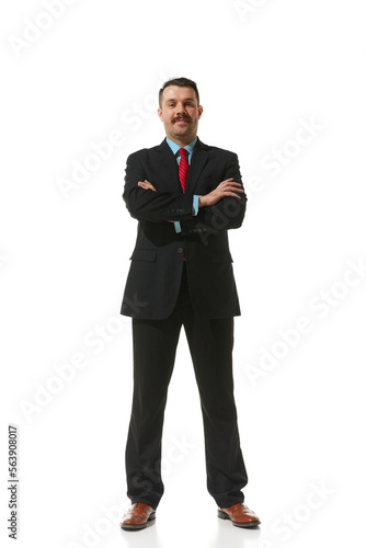 Businessman in a suit standing with positive emotions over white studio background. Successful deal, achievement. Concept of business, career, innovations, ad