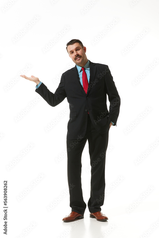 Businessman in a suit showing gesture with hand over white studio background. Space for text. Concept of business, career, innovations, ad Businessman in a suit showing gesture with hand over white studio background. Space for text. Concept of business, career, innovations, ad