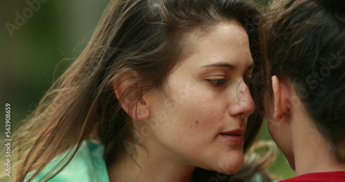 Принти на полотні Woman sharing secret whispering information to friend ear