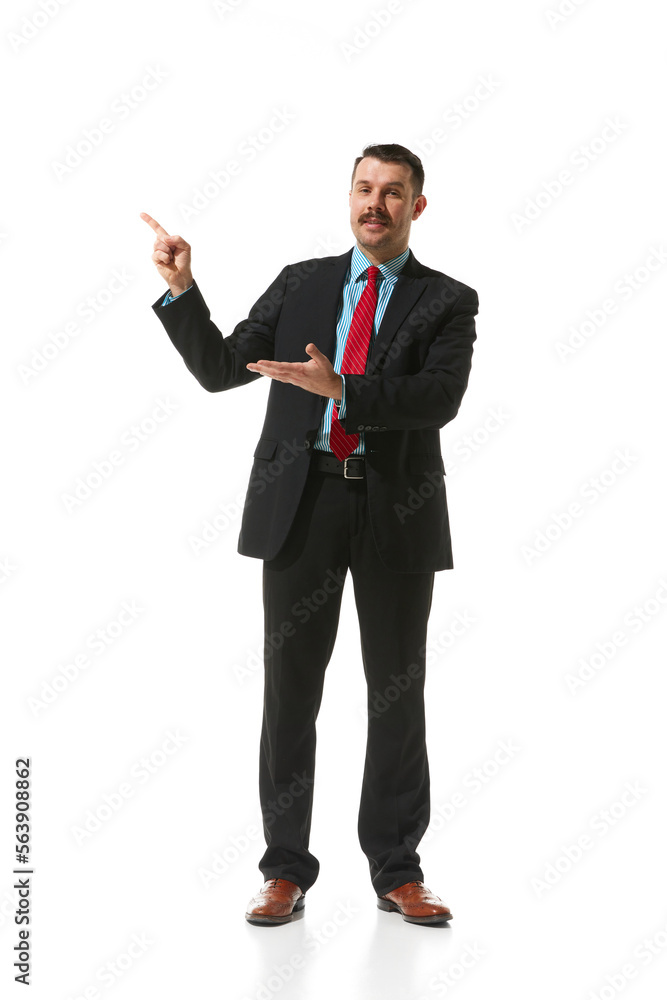 Businessman in a suit pointing with finger at blank space for text over white studio background. Plan, presentation. Concept of business, career, innovations, ad Businessman in a suit pointing with finger at blank space for text over white studio background. Plan, presentation. Concept of business, career, innovations, ad