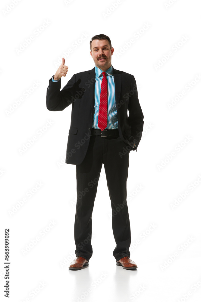 Businessman in a suit showing gesture of approvement and positivity over white studio background. Good. Concept of business, career, innovations, ad