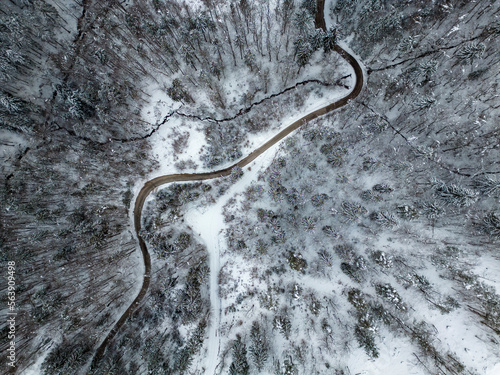 Top view of a road going through a snow covered winter nature © Gajus
