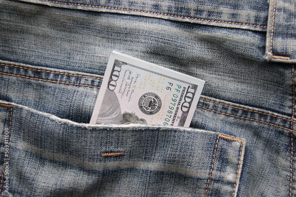 Dollar bills in a back pocket of jeans. Dollar bills in a back pocket of jeans.