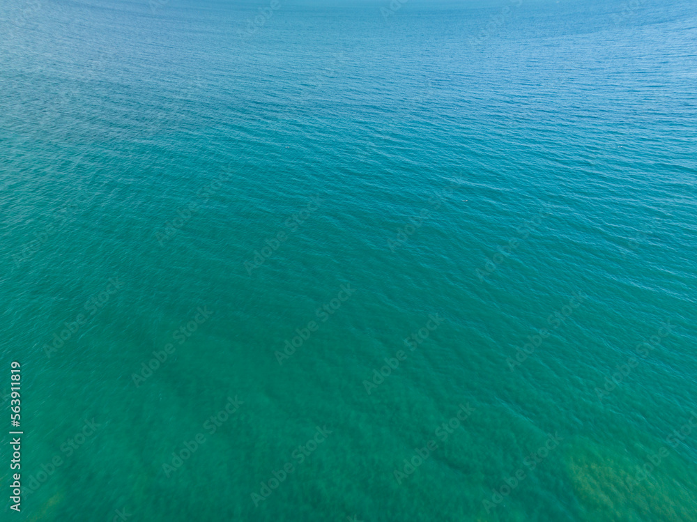 Obraz premium Sea surface aerial view,Bird eye view photo,Top view waves and water surface texture,Green sea background, Beautiful nature Amazing view sea ocean background