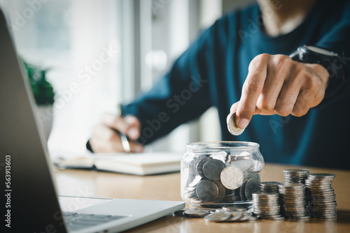 Man hands putting coins stack, Concept business finance saving money and investment.