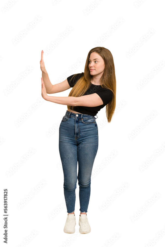 Young redhead woman pushing with hands cut out isolated Young redhead woman pushing with hands cut out isolated