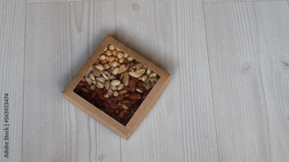 The girl puts down the box of nuts The girl puts down the box of nuts