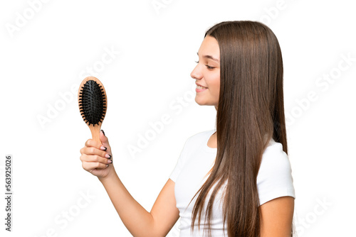 Teenager caucasian girl with hair comb over isolated background with happy expression