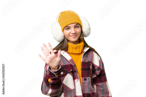 Teenager caucasian girl wearing winter muffs over isolated background counting five with fingers