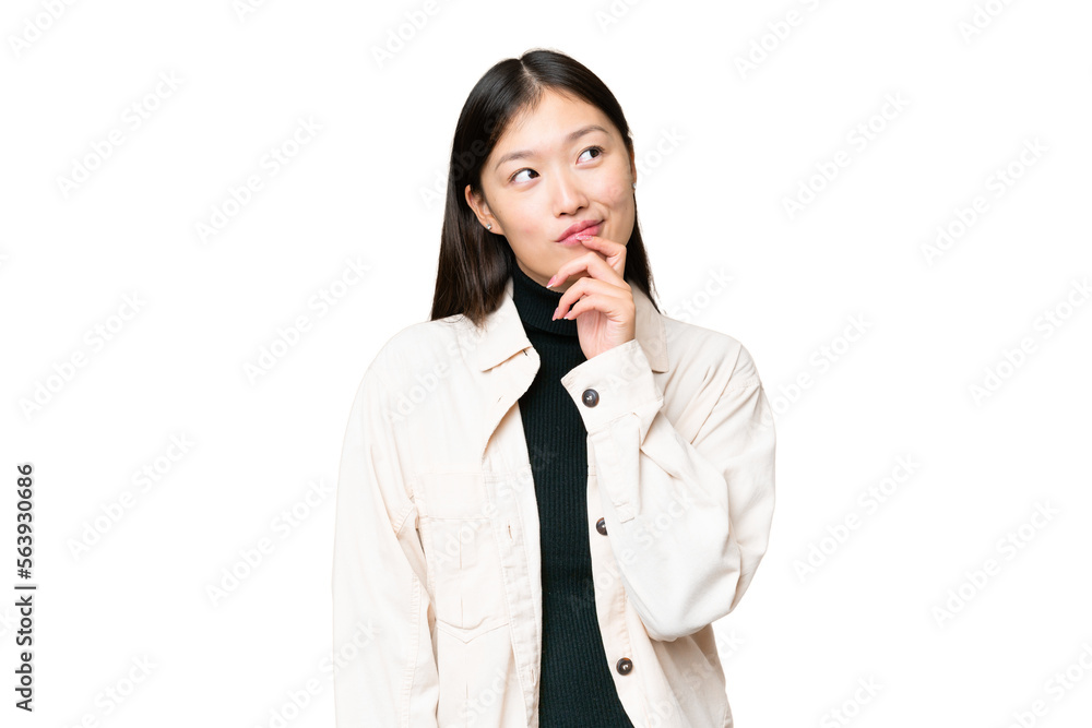 Young Asian woman over isolated chroma key background and looking up Young Asian woman over isolated chroma key background and looking up